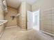 Spacious walk-in closet with built in shelving, carpet, and a view into bathroom at 14044 Chicora Crossing Blvd, Orlando, FL 32828