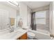 Bathroom featuring shower and tub combo and marble tile walls at 14213 Turning Leaf Dr, Orlando, FL 32828