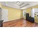 Bedroom with wood-look flooring and tray ceiling and natural light from two windows at 14213 Turning Leaf Dr, Orlando, FL 32828