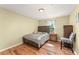 Cozy bedroom features wood-look floors, plush bed, and natural light at 14213 Turning Leaf Dr, Orlando, FL 32828