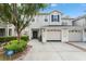 Well maintained two-story townhouse with a two-car garage and manicured landscaping at 14213 Turning Leaf Dr, Orlando, FL 32828