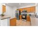 Updated kitchen featuring stainless steel appliances, granite countertops, and tile flooring at 14213 Turning Leaf Dr, Orlando, FL 32828