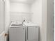 Laundry room with modern, front loading Samsung washer and dryer at 14213 Turning Leaf Dr, Orlando, FL 32828