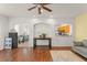 Open-concept living room features hardwood floors, stylish furniture, and archways to other rooms at 14213 Turning Leaf Dr, Orlando, FL 32828