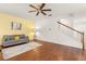 Spacious living room with hardwood floors, ceiling fan, and staircase access at 14213 Turning Leaf Dr, Orlando, FL 32828