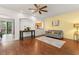 Inviting living room with hardwood floors, ceiling fan, and abundant natural light at 14213 Turning Leaf Dr, Orlando, FL 32828