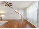 Open living room with wood floors, a staircase, and large windows for natural light at 14213 Turning Leaf Dr, Orlando, FL 32828