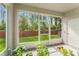 Screened patio area with view of backyard, brick fence, plants and greenery at 14213 Turning Leaf Dr, Orlando, FL 32828