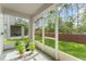 Screened patio area featuring plants, backyard view and brick fence at 14213 Turning Leaf Dr, Orlando, FL 32828