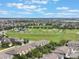 Landscaped townhome community with a green field and community park visible at 15477 Blackbead St, Winter Garden, FL 34787