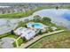 Aerial view of community pool, clubhouse, and scenic lake, offering luxurious amenities and tranquil surroundings at 15477 Blackbead St, Winter Garden, FL 34787