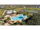 Aerial view of community pool and amenity center overlooking a scenic pond at 15477 Blackbead St, Winter Garden, FL 34787