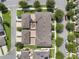 An aerial view of a townhouse community featuring manicured lawns, sidewalks, and shared outdoor living spaces at 15477 Blackbead St, Winter Garden, FL 34787