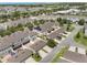 Aerial view of townhomes with driveways, landscaping, and solar panels on some roofs at 15477 Blackbead St, Winter Garden, FL 34787