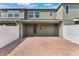 A view of the unit's brick-paved back patio and white vinyl fencing at 15477 Blackbead St, Winter Garden, FL 34787