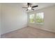 Neutral bedroom features carpeted floors, large windows, and a ceiling fan at 15477 Blackbead St, Winter Garden, FL 34787