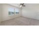 Bright bedroom with carpet floors, a ceiling fan, and two large windows at 15477 Blackbead St, Winter Garden, FL 34787