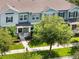 Beautiful townhome facade with mature shade trees and landscaped grounds at 15477 Blackbead St, Winter Garden, FL 34787