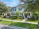 Charming two-story townhome features a beautifully landscaped yard and inviting front porch at 15477 Blackbead St, Winter Garden, FL 34787