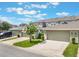 Charming townhouse featuring a well-manicured lawn, and two-car garages, creating an inviting curb appeal at 15477 Blackbead St, Winter Garden, FL 34787