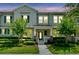 Inviting townhouse exterior with manicured landscaping and charming architectural details at 15477 Blackbead St, Winter Garden, FL 34787