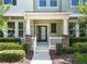Inviting front porch featuring classic columns, manicured landscaping, and a welcoming entrance at 15477 Blackbead St, Winter Garden, FL 34787