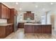 Spacious kitchen features granite counters, stainless steel appliances, and wood flooring at 15477 Blackbead St, Winter Garden, FL 34787