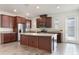 Spacious kitchen featuring an island, stainless steel appliances, and wood cabinetry at 15477 Blackbead St, Winter Garden, FL 34787