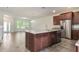 Modern kitchen with granite countertops, stainless steel appliances, and an island at 15477 Blackbead St, Winter Garden, FL 34787