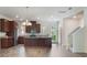Open-concept kitchen includes island, wooden cabinets, stainless steel appliances, and wood flooring at 15477 Blackbead St, Winter Garden, FL 34787