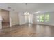 Spacious living room featuring stylish light fixture and plenty of room for entertaining at 15477 Blackbead St, Winter Garden, FL 34787