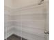 Walk-in pantry features multiple shelves for ample storage in this home at 15477 Blackbead St, Winter Garden, FL 34787