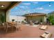 Cozy patio with string lights features a dining area, fire pit, seating, and a cornhole game at 15477 Blackbead St, Winter Garden, FL 34787