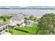 An aerial view of the home showcasing a pool, landscaped yard, and a dock on the water at 15779 Tangerine Dream Ct, Winter Garden, FL 34787