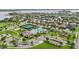 Community aerial view showcasing amenities: a pool, tennis courts, and a playground in a scenic setting at 15779 Tangerine Dream Ct, Winter Garden, FL 34787
