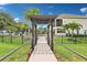 Backyard walkway leads to a pergola, pool, and waterfront, creating a seamless indoor-outdoor flow at 15779 Tangerine Dream Ct, Winter Garden, FL 34787