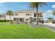 Expansive backyard features lush greenery, a patio, and a lake view, ideal for relaxation and entertaining at 15779 Tangerine Dream Ct, Winter Garden, FL 34787