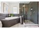 Elegant bathroom with a glass enclosed shower, soaking tub, and tile floors at 15779 Tangerine Dream Ct, Winter Garden, FL 34787