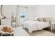 Cozy bedroom with a white comforter, area rug, and natural light at 15779 Tangerine Dream Ct, Winter Garden, FL 34787