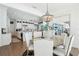 Dining area features lake views, casual chandelier, and open access to the kitchen at 15779 Tangerine Dream Ct, Winter Garden, FL 34787