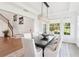 Dining room features modern chandelier, nearby staircase, and great view of the landscaped yard at 15779 Tangerine Dream Ct, Winter Garden, FL 34787
