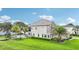 An exterior shot of the home showing a view of the pool and surrounding greenery at 15779 Tangerine Dream Ct, Winter Garden, FL 34787