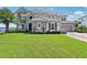 Charming two-story home with a stone facade, lush lawn, and meticulous landscaping at 15779 Tangerine Dream Ct, Winter Garden, FL 34787