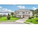 Stunning exterior elevation with a brick driveway and an oversized three-car garage at 15779 Tangerine Dream Ct, Winter Garden, FL 34787