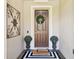 Charming front door adorned with a wreath, decorative planters, and a welcoming doormat at 15779 Tangerine Dream Ct, Winter Garden, FL 34787