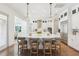 Modern kitchen island with stainless appliances, elegant pendant lighting, and barstool seating at 15779 Tangerine Dream Ct, Winter Garden, FL 34787