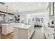 Gourmet kitchen with spacious islands and countertops, modern lighting, and water views at 15779 Tangerine Dream Ct, Winter Garden, FL 34787