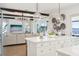 Bright, open kitchen featuring a center island and seamless flow into the living area with water views at 15779 Tangerine Dream Ct, Winter Garden, FL 34787
