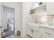 Bright laundry room with white cabinetry, gold hardware, and a view to another room in the house at 15779 Tangerine Dream Ct, Winter Garden, FL 34787