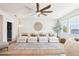 Bright living room featuring a large sectional sofa, area rug, modern lighting, and a lake view at 15779 Tangerine Dream Ct, Winter Garden, FL 34787